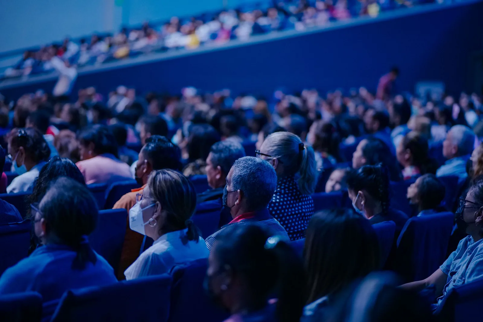 Conference audience in blue lighting